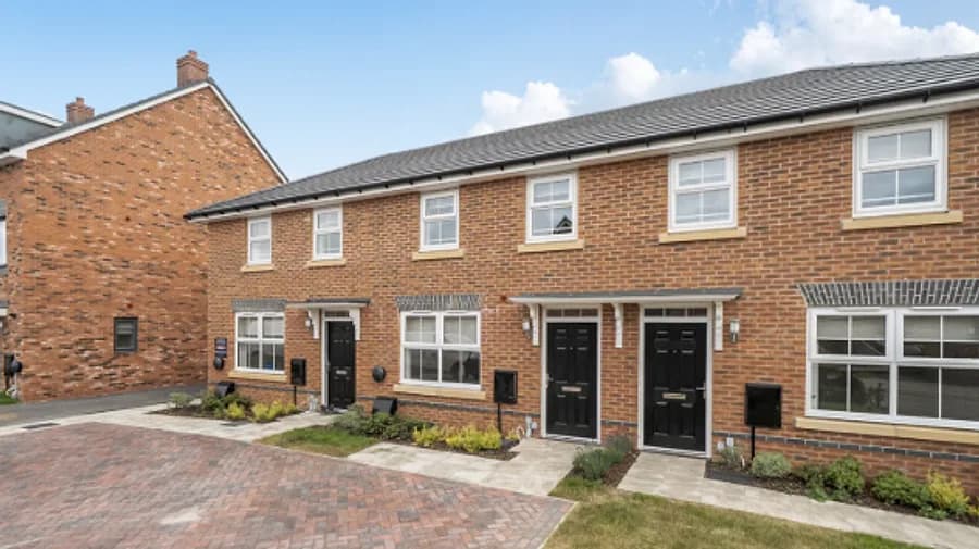 A row of modern new-build brick terraced homes